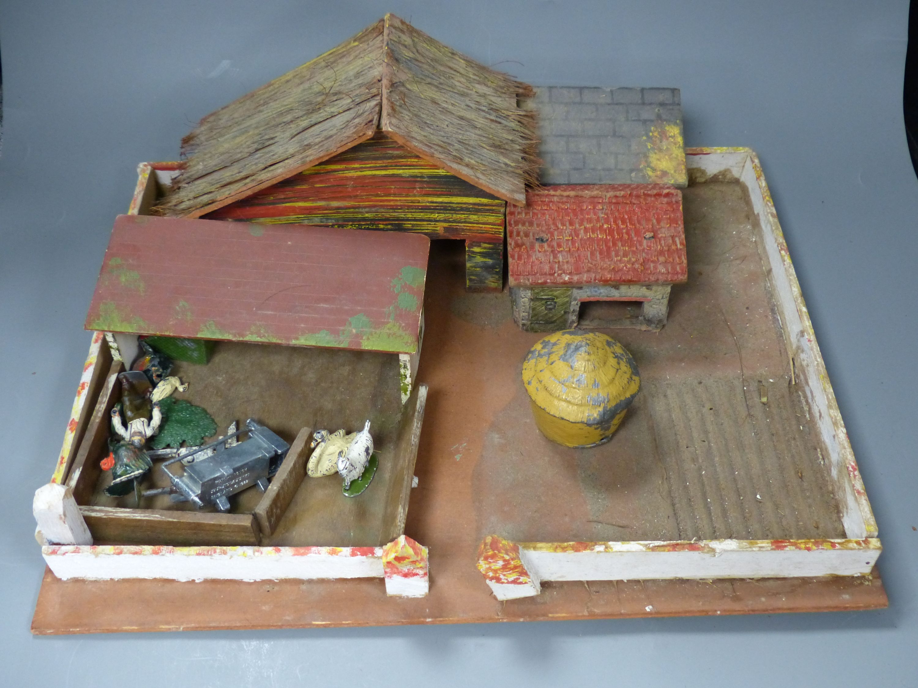 A model farmhouse and a small quantity of lead figures
